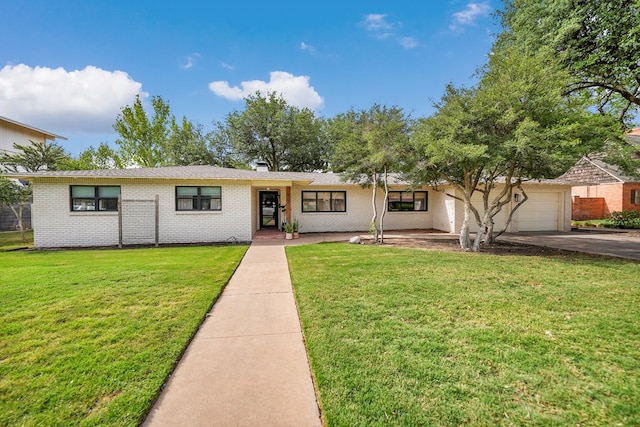907 Harvard Ave, Midland, TX 79701 - view of front of property with an attached garage, driveway, a front yard, and brick siding