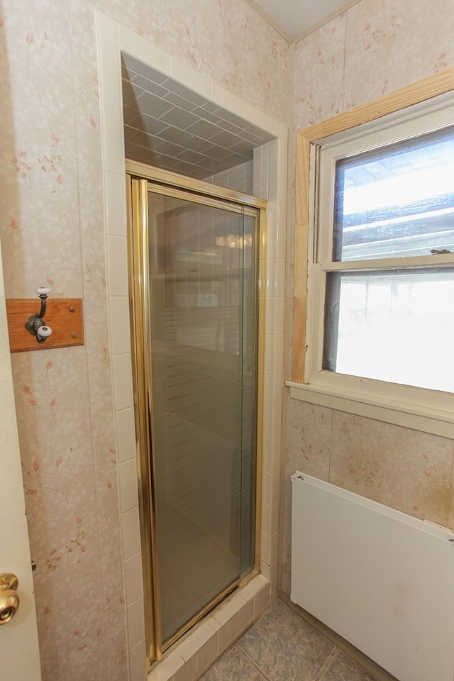 bathroom featuring tile patterned flooring and an enclosed shower