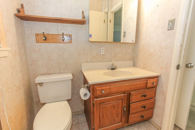 bathroom featuring tile patterned floors, vanity, and toilet