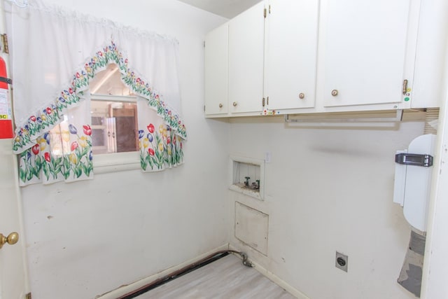 laundry area featuring electric dryer hookup, hookup for a washing machine, hardwood / wood-style floors, and cabinets