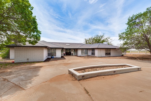 ranch-style home featuring brick siding