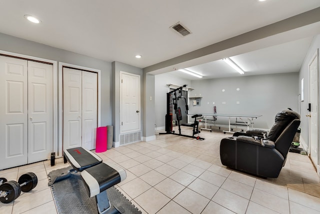 exercise area with light tile patterned floors and recessed lighting