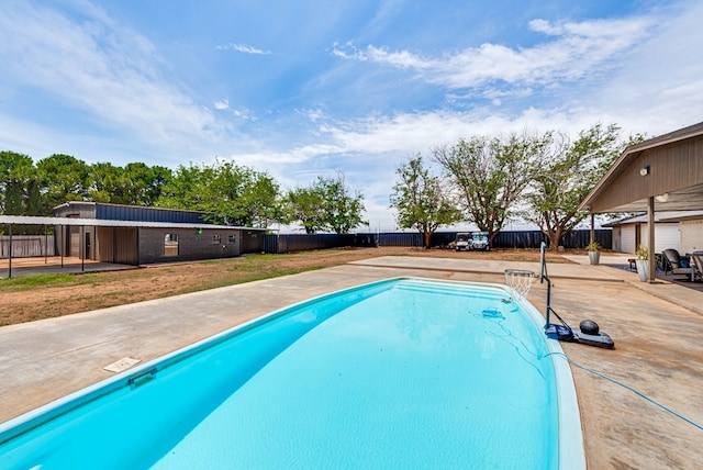 view of pool featuring fence