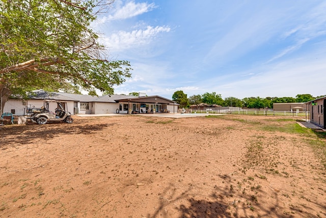 view of yard with fence and a patio