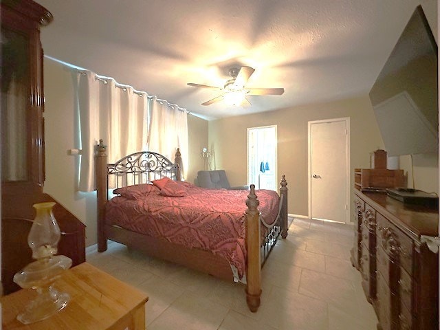 bedroom with ceiling fan, baseboards, and light tile patterned floors