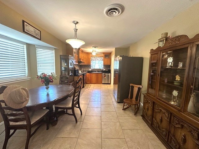 dining room with visible vents and light tile patterned floors