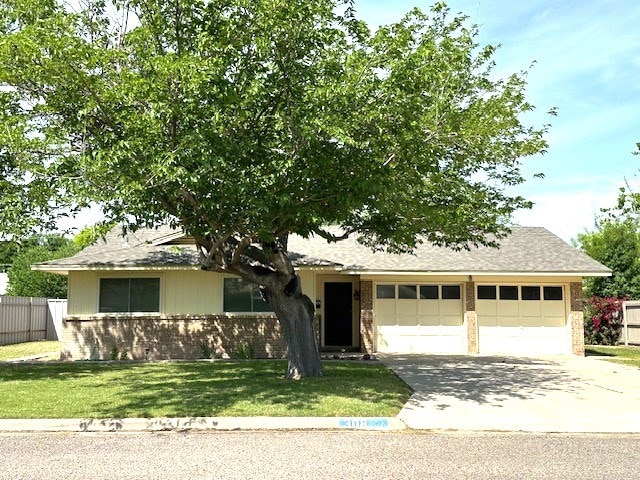 single story home with fence, driveway, a front yard, and a garage