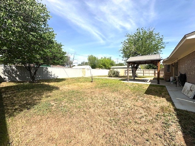view of yard featuring a fenced backyard, a gazebo, and a patio