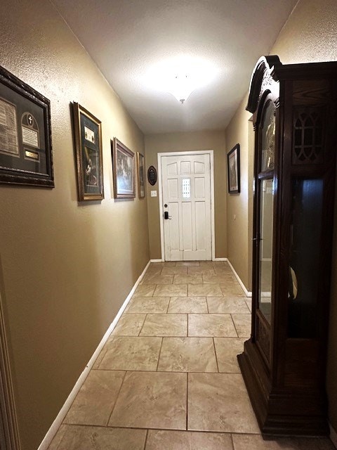 doorway to outside with baseboards and stone finish floor