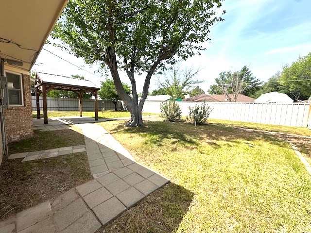 view of yard featuring a fenced backyard, a gazebo, and a patio area