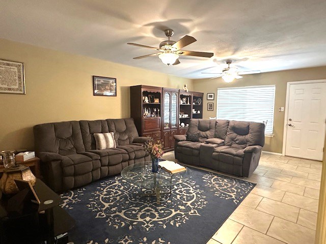 tiled living area featuring a ceiling fan