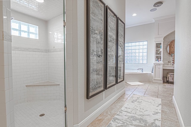 bathroom featuring a garden tub, crown molding, a wealth of natural light, and a shower stall