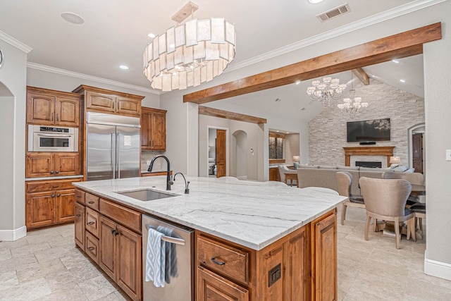 kitchen with visible vents, arched walkways, stainless steel appliances, and a sink