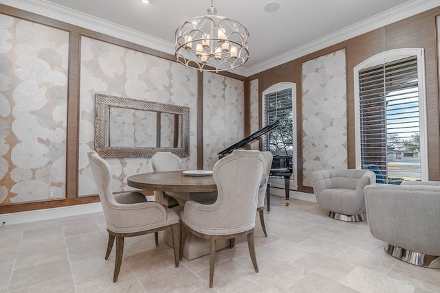 dining space with baseboards, ornamental molding, and a notable chandelier