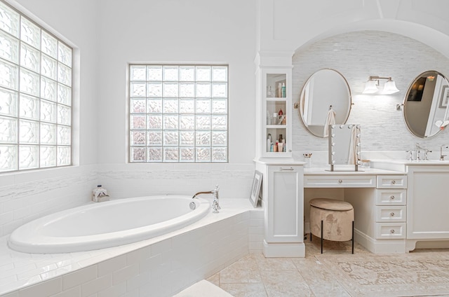 full bathroom featuring tile patterned flooring, a bath, and vanity