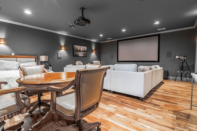 cinema with crown molding, light wood-style floors, recessed lighting, and baseboards