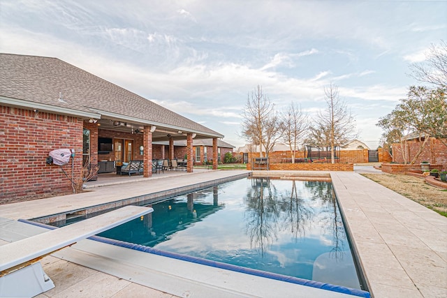 view of pool with a patio, an outdoor living space, fence, and a fenced in pool