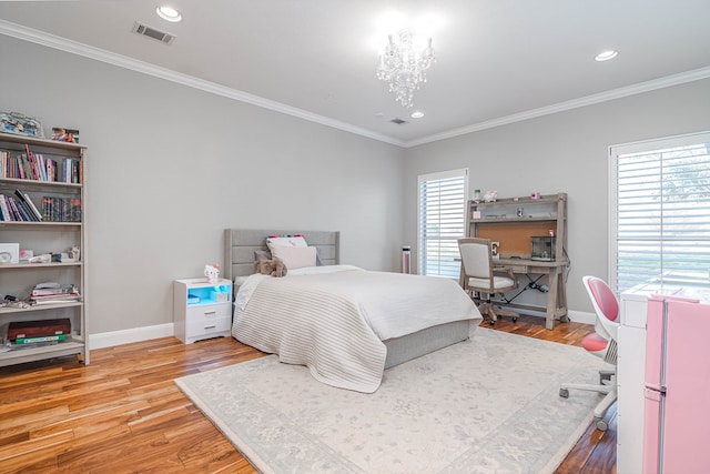 bedroom featuring light wood-style floors, multiple windows, visible vents, and ornamental molding