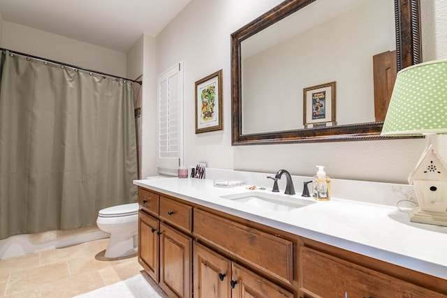 bathroom with curtained shower, vanity, and toilet