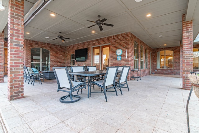 view of patio with outdoor dining area and ceiling fan