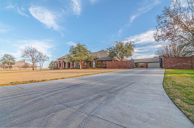 ranch-style home with a front yard and fence