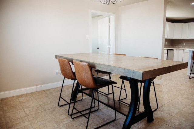 dining space featuring a notable chandelier