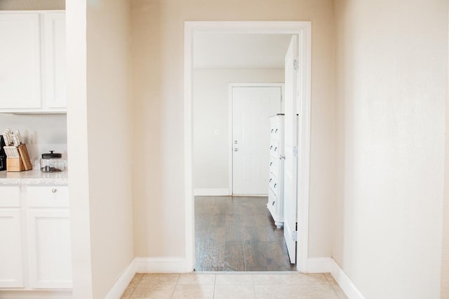 hallway with light hardwood / wood-style floors