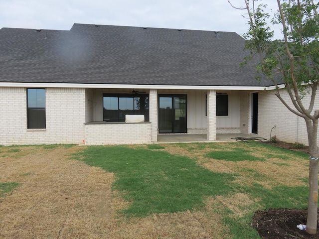 9811 E County Rd 108, Midland, TX 79706 - rear view of house with a shingled roof, brick siding, a patio area, and a lawn