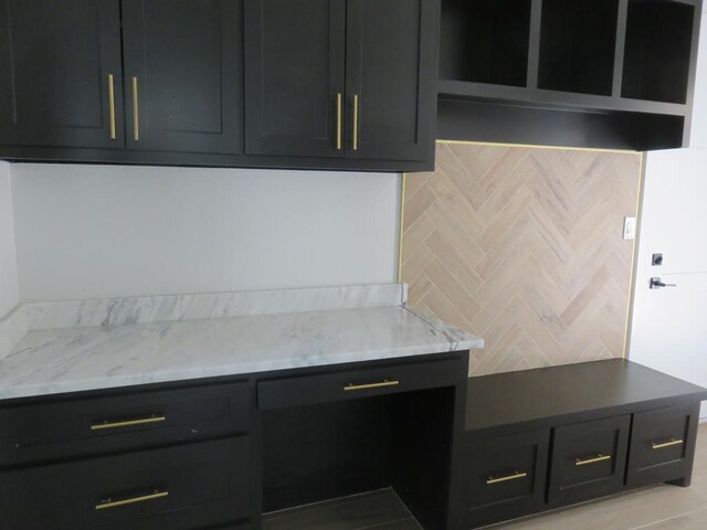 9811 E County Rd 108, Midland, TX 79706 - kitchen with light stone countertops and dark cabinetry