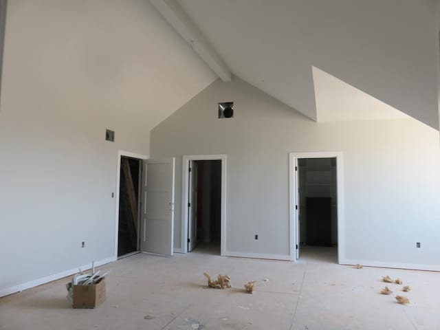 9811 E County Rd 108, Midland, TX 79706 - unfurnished bedroom featuring high vaulted ceiling, beamed ceiling, a walk in closet, and baseboards