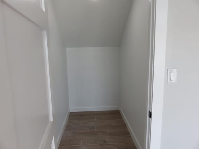 9811 E County Rd 108, Midland, TX 79706 - bonus room featuring dark wood-style flooring and vaulted ceiling