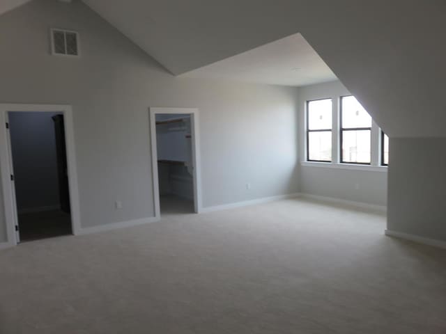 9811 E County Rd 108, Midland, TX 79706 - additional living space featuring light carpet and high vaulted ceiling