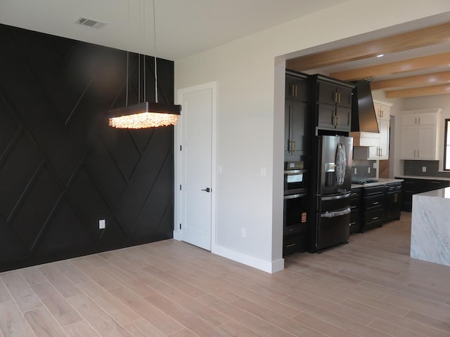 9811 E County Rd 108, Midland, TX 79706 - kitchen featuring premium range hood, refrigerator with ice dispenser, a chandelier, backsplash, and light wood-style flooring