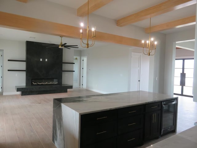 9811 E County Rd 108, Midland, TX 79706 - kitchen featuring a chandelier, dark cabinets, beamed ceiling, a ceiling fan, and beverage cooler
