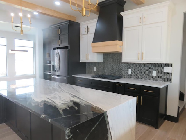 9811 E County Rd 108, Midland, TX 79706 - kitchen featuring premium range hood, freestanding refrigerator, decorative backsplash, black electric cooktop, and light wood finished floors
