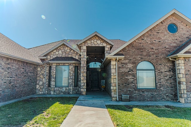 property entrance with a lawn