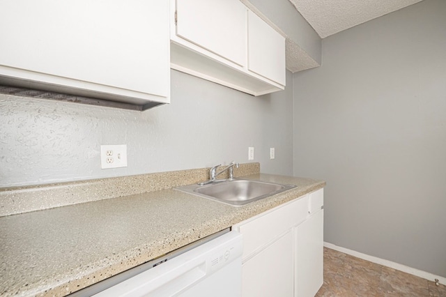 kitchen featuring dishwasher, sink, white cabinets, and a textured ceiling