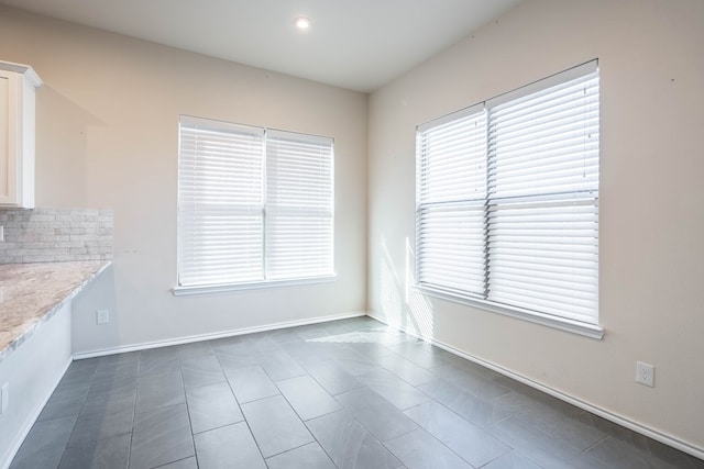 unfurnished dining area featuring plenty of natural light