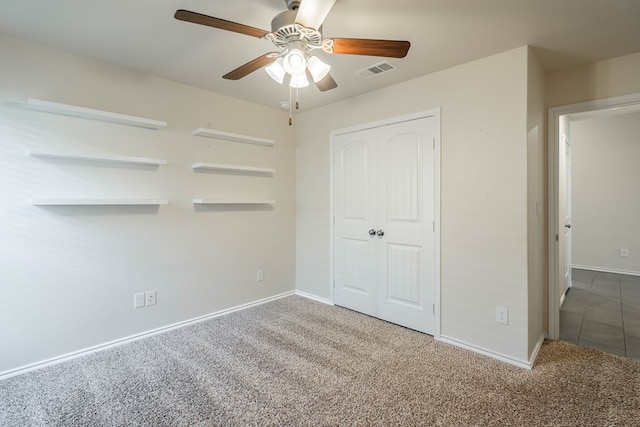 unfurnished bedroom featuring carpet, ceiling fan, and a closet