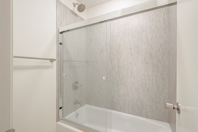 bathroom featuring shower / bath combination with glass door