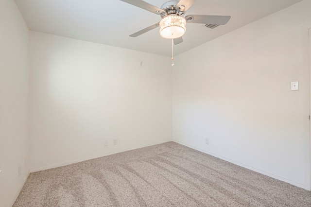 spare room featuring light colored carpet and ceiling fan