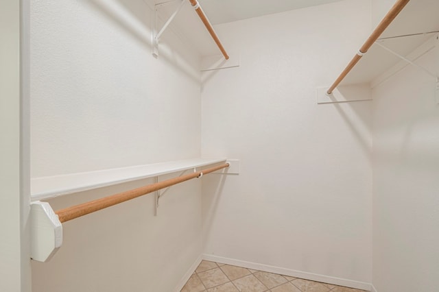 spacious closet featuring light tile patterned floors