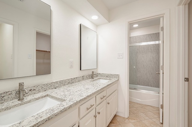 bathroom featuring tile patterned floors, vanity, and shower / bath combination with glass door