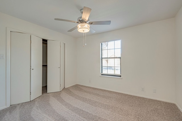 unfurnished bedroom with ceiling fan, light carpet, and a closet