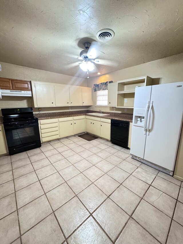 2100 42nd St, Snyder, TX 79549 - kitchen featuring ceiling fan, sink, black appliances, light tile patterned floors, and cream cabinetry