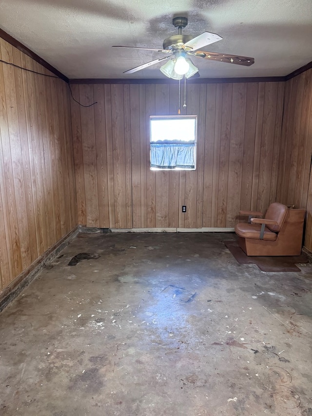 2100 42nd St, Snyder, TX 79549 - unfurnished room featuring a textured ceiling, ceiling fan, and wooden walls