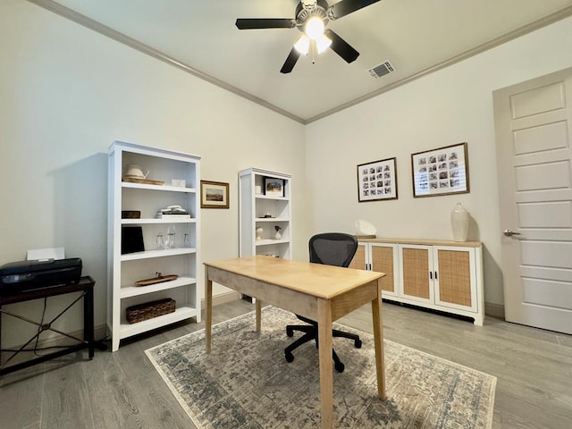 office featuring hardwood / wood-style flooring, ceiling fan, and crown molding