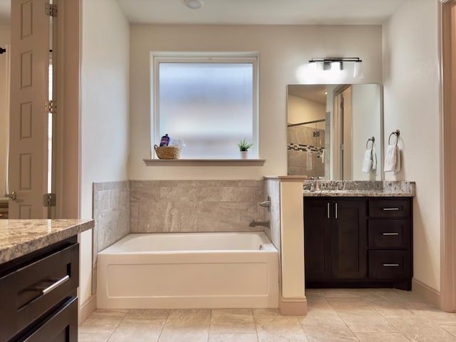 bathroom featuring plus walk in shower, tile patterned flooring, and vanity