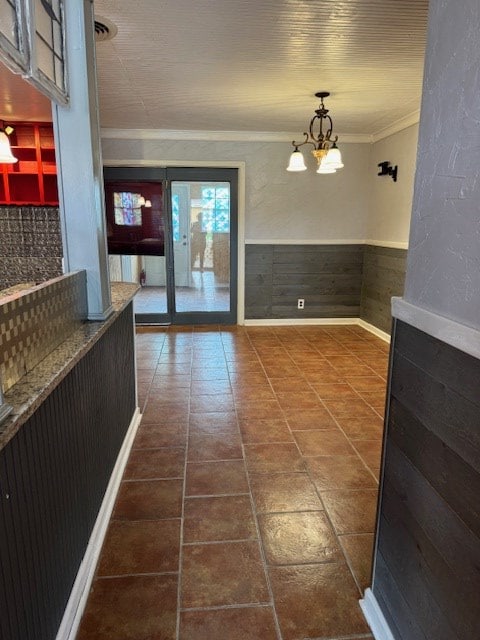 906 W 5th St, Fort Stockton, TX 79735 - corridor with crown molding, a chandelier, and wainscoting