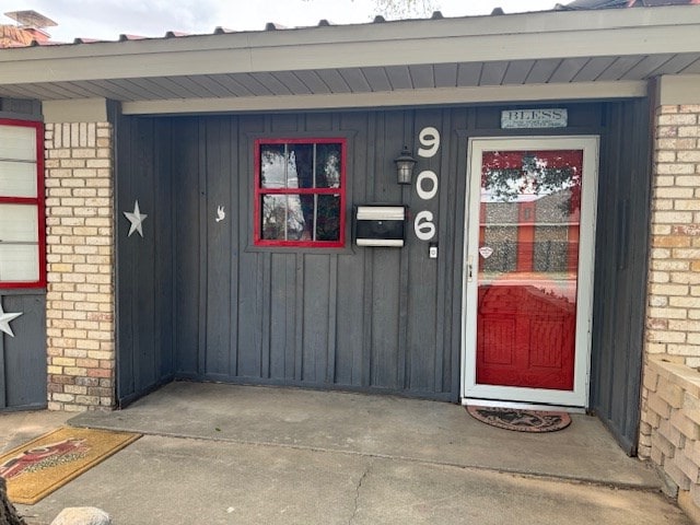 906 W 5th St, Fort Stockton, TX 79735 - view of exterior entry with board and batten siding and brick siding